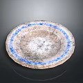 Hand Carved Circular Stone Sculpture With Blue Rim And Textured Surface