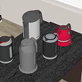 Modern Kitchen Appliances Featuring Colorful Kettles Placed on Black Table Top