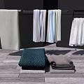 Colorful Striped and Plain Towels Hanging on Racks and Folded on Wooden Floor