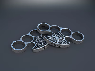 Metal Brass Knuckles With Decorative Skull Pattern And Multiple Finger Holes 3d model