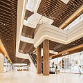 Modern Shopping Mall Atrium Interior Design With Wooden Ceiling Escalators And Brand Stores