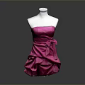 Pink Strapless Ruffled Dress With Bow Accent Displayed On White Mannequin