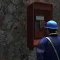 Man in Blue Hard Hat and Work Uniform Using Telephone Booth Next to Rocky Wall