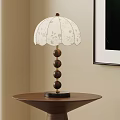 White Floral Patterned Table Lamp With Wooden Spherical Base On Round Brown Side Table