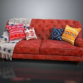 Red Tufted Two Seater Sofa With Colorful Pillows And Cozy Blanket