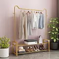 Golden Clothes Rack With Hanging Clothes Shoes Hats Storage Box Green Plants And Pink Wall