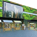 Green Plant Wall Building Featuring Outdoor Stalls With Colorful Awnings On Paved Ground