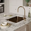 Modern Kitchen Sink With Gold Faucet On Marble Countertop And Cabinets