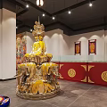 Religious Worship Space Featuring Yellow Arch Altar Table Candlesticks Incense Burners Mats And Colorful Murals