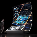 Man Observing High Tech Sand Table With Curved Display Urban Map And Building Models