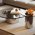 Modern Glass Top Coffee Table With Metallic Base Stack Of Books And Fruit Bowl