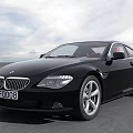 Black BMW Coupe Car With Sleek Design On Open Road And Sky Background