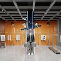 Modern Clothing Store Interior With Orange Walls Mannequin Leather Jacket Camouflage Pants Hanging T-shirts