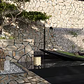 Outdoor Courtyard Design With Stone Wall Waterfall Hammock Lantern And Green Plants