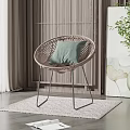 Rattan Leisure Chair with Green Cushion Metal Legs and Wicker Screen on Light Rug