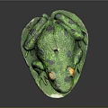 Green Frog Sculpture Sitting On Leaf With Yellow Eyes Black Spots And Candle On Head
