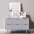 White Console Table with Vase Red Flowers Statue Photo Frame Books Against Light Wall