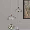 Elegant White Patterned Pendant Lights With Dark Base In Room With Decorative Art And Vase