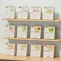 Ornament Decoration Set Featuring Colorful Monthly Calendar Designs On Wooden Shelves With Cartoon Patterns