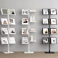Three Different Colored Modern Bookcases With Multiple Shelves Displaying Books And Photo Frames