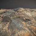 Desolate Rocky Mountain Landscape With Layered Terrain Gullies And Multicolored Hues In Brown Orange Blue