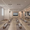 Bright Yoga Studio With Arranged Yoga Mats Foam Rollers TV Screens And Mirrors