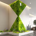 Modern Indoor Landscape Featuring Hourglass Shaped Moss Wall With Wall Clock And Decorative Plants