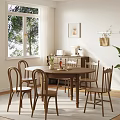 Cozy Wooden Dining Chairs Around Round Table in Bright Natural Room with Window Plants