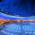 CENTEX Venue With Large Curved Screen Cityscape Blue Laser Beams White Seats Circular Arrangement