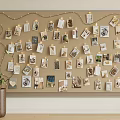 Corkboard Photo Wall Decorated with Photos Cards and String Lights Beside Vase with Green Plants