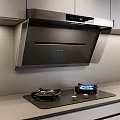 Modern Kitchen Appliances Featuring Stainless Steel Range Hood And Gas Stove On Countertop