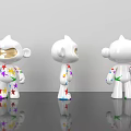 White Cartoon Dolls with Colorful Star Patterns Displayed in Three Angles on Shiny Black Surface
