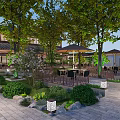 Traditional Garden Landscape With Trees Outdoor Seating Umbrellas Stone Paved Ground Greenery And Lantern Lights