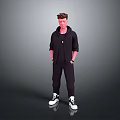 Man Standing in Black Hoodie and Pants with Hands in Pockets White Sneakers Gray Background