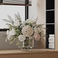 White and Pink Flowers Arrangement in Transparent Glass Vase with Green Leaves and Bookshelf