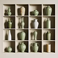 Ceramic Vessels in Green and White with Various Shapes on Display Shelves