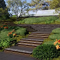 Park Landscape with Stone Steps Lush Green Lawns Trees Stone Walls and Orange Flowers