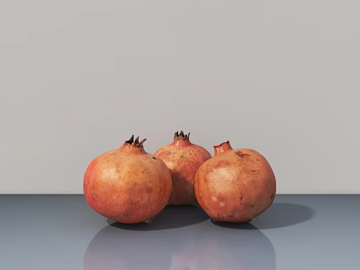 Fresh Ripe Pomegranates Placed On Gray Tabletop With Light Gray Background 3d model