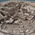 Ancient Stone Ruins With Circular Stone Walls And Scattered Blocks In Archaeological Site