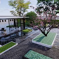 Serene Garden Landscape With Green Lawn Cherry Blossom Tree Water Pond And Paved Seating Area
