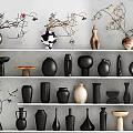 Ceramic Vessels in Various Shapes and Colors on White Shelves with Twig Decorations