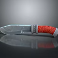 Silver Blade Tactical Weapon Knife With Red Wrapped Handle And SOCA Mark On Black Reflective Surface