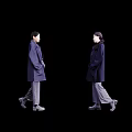 Two women wearing dark colored coats and gray pants walking in stylish outfit