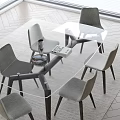 Modern Glass Dining Table With Four Gray Chairs Wine Glass And Book Near Bright Window