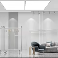 Modern Minimalist Clothing Store Interior With White Walls Clothing Racks And Sofa In Open Space