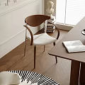 Modern Wooden Dining Chair With Armrests And Light Fabric Seat Near Wooden Table Natural Light