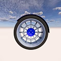Silver Rimmed Tire with Black Outer Ring and Blue Center Cap Against Blue Sky White Ground