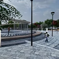 Park Landscape With Lush Trees White Buildings Circular Plazas And Paths
