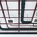 Industrial Style Building Interior Featuring Exposed Metal Ceiling Pipes And Air Vents