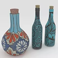 Three Decorative Wine Bottles with Blue Black Hues Floral Leaf Patterns and Cork Stoppers